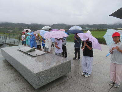 伝承館見学の前に、雨の中、海に向かって手を合わせました